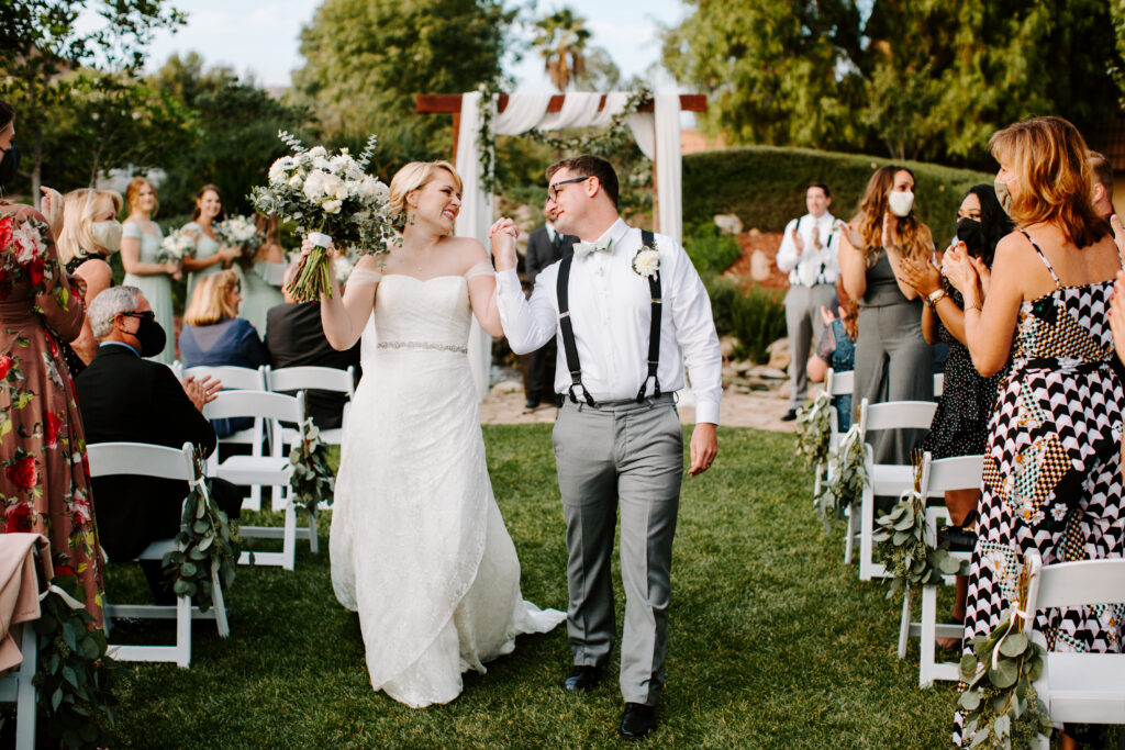 Brett and Alison walking back down from the aisle at the Harmony Estate
