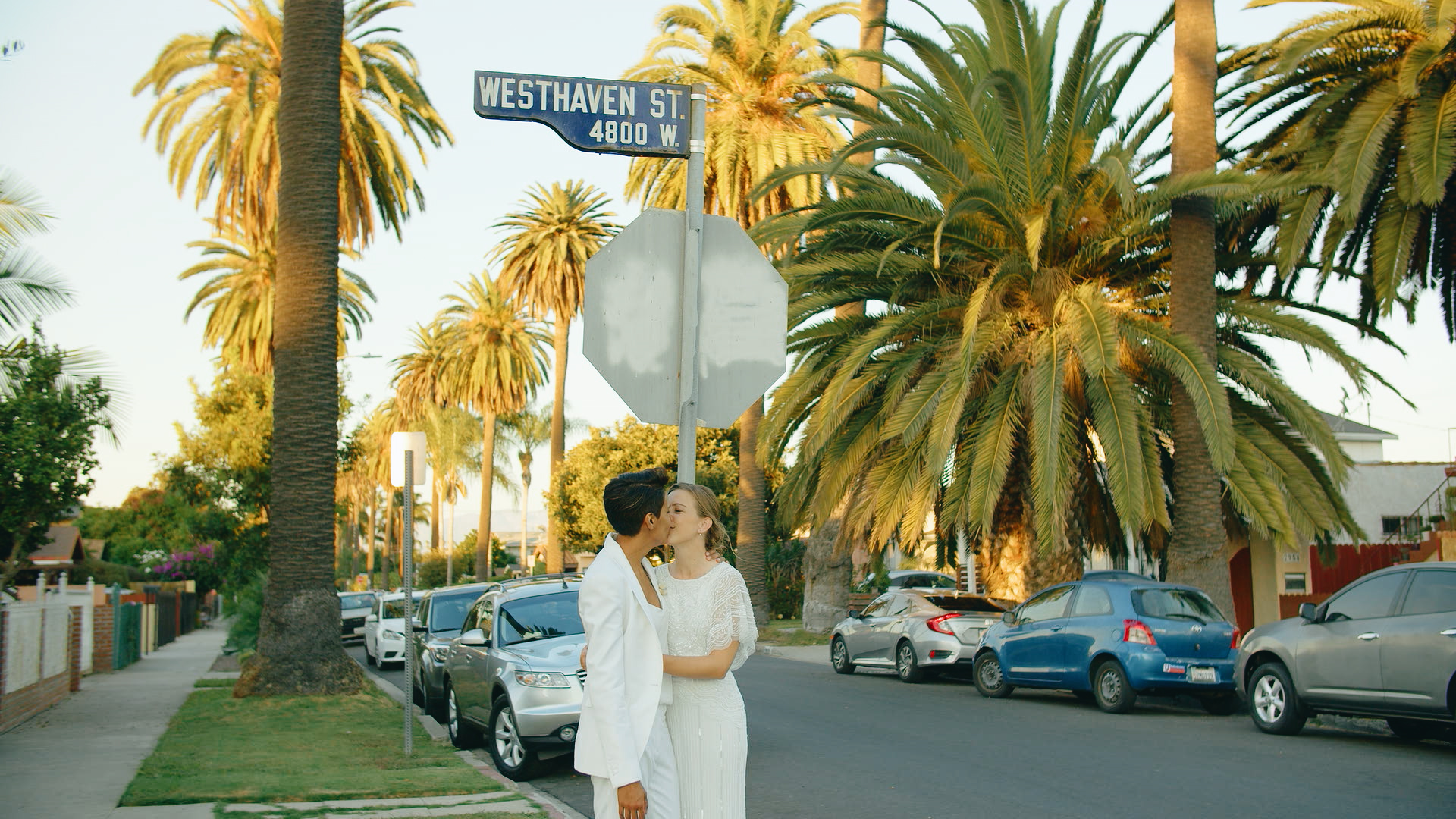 Brides_Kissing_Under_a_street_Sign