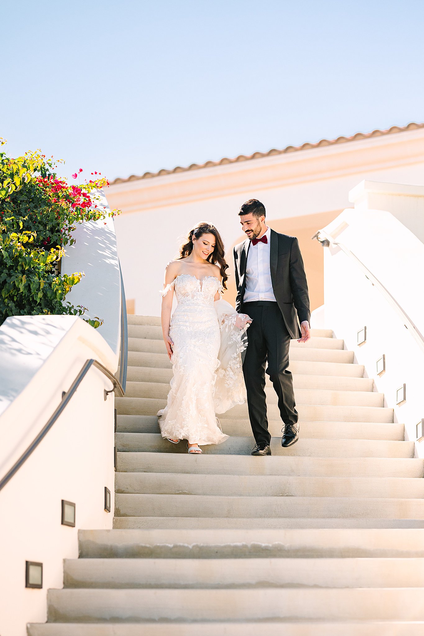 Bride and groom walking down the steps in La Quinta Country club