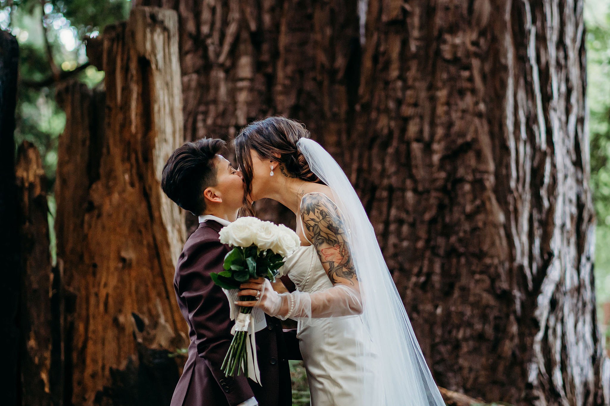 Bride and Bride kiss in the Santa Cruz Redwoods