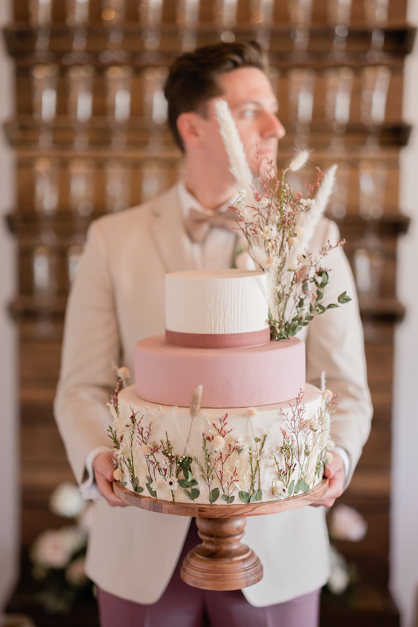 groom holding cake